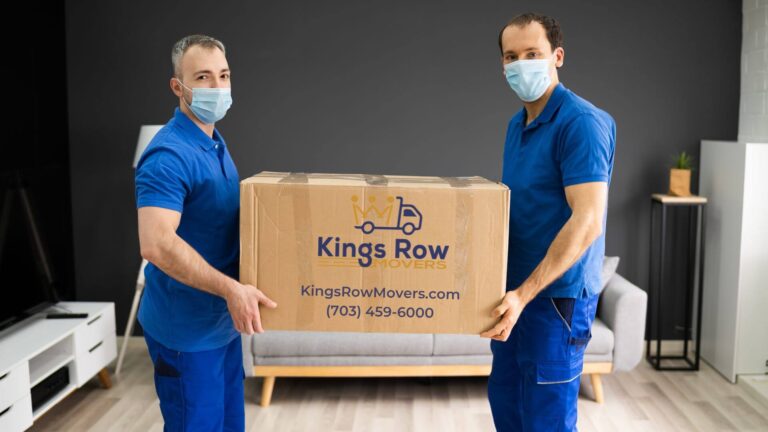 Professional movers from Kings Row moving customer's belongings into a storage unit.